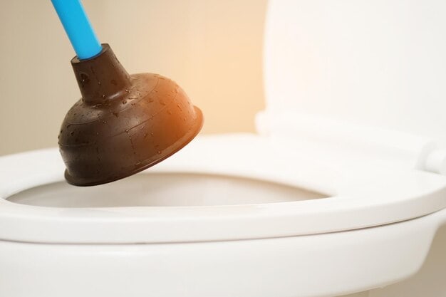 Toilet plunger used to unblock a clogged toilet drain.